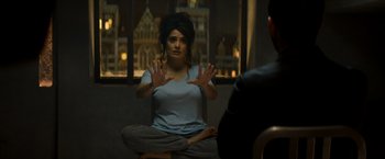 Movie still from “The Hitman's Bodyguard” (2017), directed by Patrick Hughes – A woman sitting on the ground in front of a man; Medium shot, Over the shoulder angle