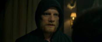 Movie still from “The Hitman's Bodyguard” (2017), directed by Patrick Hughes – A person wearing a hooded jacket; Close Up shot, Over the shoulder angle