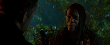 Movie still from “The Hitman's Bodyguard” (2017), directed by Patrick Hughes – An older man holding a cell phone in his hand; Close Up shot, Over the shoulder angle