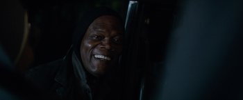 Movie still from “The Hitman's Bodyguard” (2017), directed by Patrick Hughes – A person with a smile on their face; Close Up shot, Over the shoulder angle