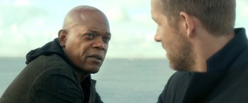Movie still from “The Hitman's Bodyguard” (2017), directed by Patrick Hughes – Two men are facing each other in front of a body of water; Close Up shot, Over the shoulder angle