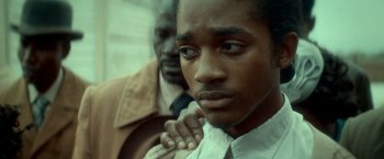 Movie still from “The Hitman's Bodyguard” (2017), directed by Patrick Hughes – A man standing next to another man with his hand on his chest; Close Up shot, Over the shoulder angle