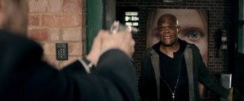 Movie still from “The Hitman's Bodyguard” (2017), directed by Patrick Hughes – A man taking a picture of himself in a mirror; Medium shot, Over the shoulder angle