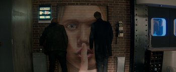 Movie still from “The Hitman's Bodyguard” (2017), directed by Patrick Hughes – Two people standing in front of a painting of a woman's face; Medium shot, Over the shoulder angle
