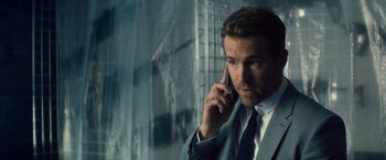 Movie still from “The Hitman's Bodyguard” (2017), directed by Patrick Hughes – A person talking on a cell phone; Close Up shot, Over the shoulder angle