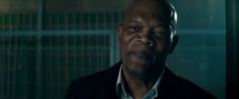 Movie still from “The Hitman's Bodyguard” (2017), directed by Patrick Hughes – An older black man wearing a black jacket and a white shirt; Close Up shot, Low angle