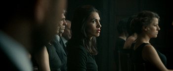 Movie still from “The Hitman's Bodyguard” (2017), directed by Patrick Hughes – A group of men and a woman sitting in front of a wall; Close Up shot, Over the shoulder angle