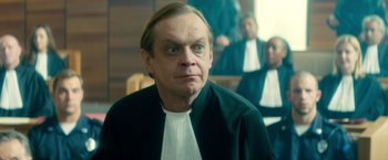 Movie still from “The Hitman's Bodyguard” (2017), directed by Patrick Hughes – A man in a black jacket and a white shirt; Close Up shot, Over the shoulder angle