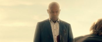 Movie still from “The Hitman's Bodyguard” (2017), directed by Patrick Hughes – A man with a blood stain on his face; Close Up shot, Low angle