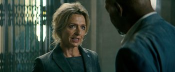 Movie still from “The Hitman's Bodyguard” (2017), directed by Patrick Hughes – A woman is talking to a man in front of a wall; Close Up shot, Over the shoulder angle