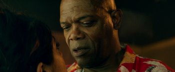 Movie still from “The Hitman's Bodyguard” (2017), directed by Patrick Hughes – An older black man with his eyes closed; Close Up shot, Over the shoulder angle