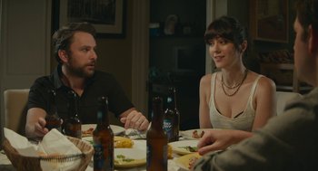 Movie still from “The Hollars” (2016), directed by John Krasinski – A group of people sitting at a dinner table; Medium shot, Over the shoulder angle