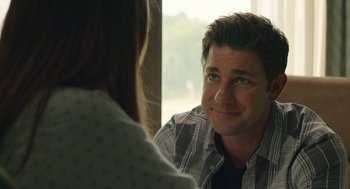 Movie still from “The Hollars” (2016), directed by John Krasinski – A man and a woman sitting in front of each other; Close Up shot, Over the shoulder angle