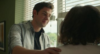 Movie still from “The Hollars” (2016), directed by John Krasinski – A man and a woman are looking at each other in front of a window; Close Up shot, Over the shoulder angle