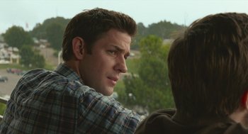 Movie still from “The Hollars” (2016), directed by John Krasinski – A person sitting on a chair; Close Up shot, Over the shoulder angle