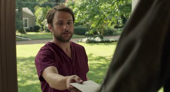 Movie still from “The Hollars” (2016), directed by John Krasinski – A man holding a piece of paper in his hand; Close Up shot, Over the shoulder angle