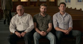 Movie still from “The Hollars” (2016), directed by John Krasinski – A group of men sitting next to each other on top of a bench; Medium shot, Over the shoulder angle