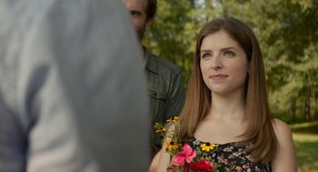Movie still from “The Hollars” (2016), directed by John Krasinski – A beautiful young woman holding a bouquet of flowers; Close Up shot, Over the shoulder angle