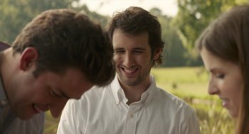 Movie still from “The Hollars” (2016), directed by John Krasinski – A man in a white dress shirt is talking to another man in a white dress shirt; Close Up shot, Over the shoulder angle