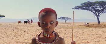 Movie still from “The Host” (2013), directed by Andrew Niccol – A young boy wearing a colorful necklace and a red necklace; Close Up shot, Low angle