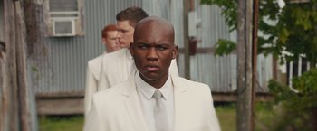 Movie still from “The Host” (2013), directed by Andrew Niccol – A man in a white suit and white tie; Medium shot, Over the shoulder angle