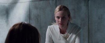 Movie still from “The Host” (2013), directed by Andrew Niccol – A woman sitting in front of a wall looking at the camera; Close Up shot, Over the shoulder angle