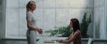 Movie still from “The Host” (2013), directed by Andrew Niccol – Two women sitting at a table talking to each other; Medium shot, Over the shoulder angle