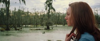 Movie still from “The Host” (2013), directed by Andrew Niccol – A woman standing in front of a body of water; Close Up shot, Over the shoulder angle