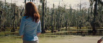 Movie still from “The Host” (2013), directed by Andrew Niccol – A woman standing in front of a body of water; Wide shot, Over the shoulder angle