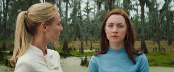 Movie still from “The Host” (2013), directed by Andrew Niccol – Two women standing next to each other in a wooded area; Close Up shot, Over the shoulder angle