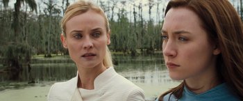 Movie still from “The Host” (2013), directed by Andrew Niccol – Two women standing next to each other near a body of water; Close Up shot, Over the shoulder angle
