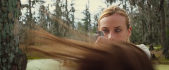 Movie still from “The Host” (2013), directed by Andrew Niccol – A woman holding a cell phone up to her face; Close Up shot, Over the shoulder angle