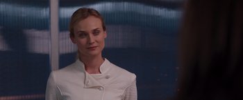 Movie still from “The Host” (2013), directed by Andrew Niccol – A woman in a white jacket standing in front of a building; Close Up shot, Over the shoulder angle