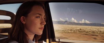 Movie still from “The Host” (2013), directed by Andrew Niccol – A woman sitting in a car looking out the window; Close Up shot, Low angle