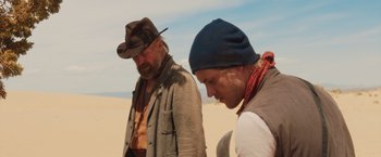 Movie still from “The Host” (2013), directed by Andrew Niccol – Two men standing next to each other in the desert; Medium shot, Low angle
