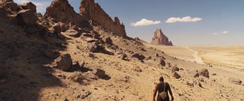 Movie still from “The Host” (2013), directed by Andrew Niccol – A man walking up a hill in the middle of the desert; Extreme Wide shot, High angle