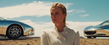 Movie still from “The Host” (2013), directed by Andrew Niccol – A woman wearing a white jacket standing on a beach; Close Up shot, Low angle