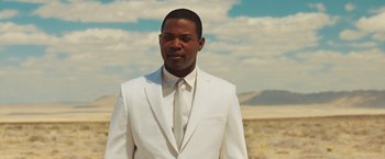 Movie still from “The Host” (2013), directed by Andrew Niccol – A man wearing a white suit and a white tie; Medium shot, Low angle