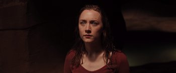 Movie still from “The Host” (2013), directed by Andrew Niccol – A woman with wet hair and a red shirt; Close Up shot, High angle