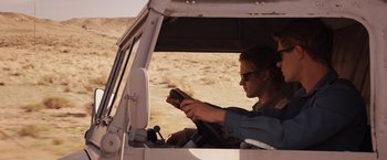 Movie still from “The Host” (2013), directed by Andrew Niccol – A man sitting in the driver's seat of a truck; Medium shot, Over the shoulder angle