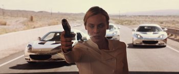 Movie still from “The Host” (2013), directed by Andrew Niccol – A woman is holding a gun in her hand; Close Up shot, Over the shoulder angle