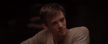 Movie still from “The Host” (2013), directed by Andrew Niccol – A person sitting down with his head tilted up; Close Up shot, Over the shoulder angle