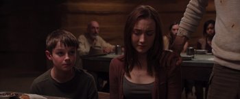 Movie still from “The Host” (2013), directed by Andrew Niccol – A woman sitting in front of a man and a boy; Medium shot, Over the shoulder angle