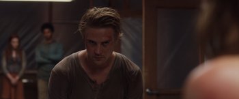 Movie still from “The Host” (2013), directed by Andrew Niccol – A man with long blonde hair is looking at the camera; Close Up shot, Over the shoulder angle
