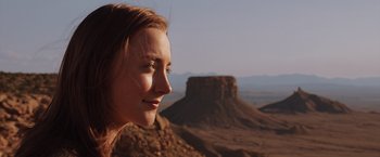 Movie still from “The Host” (2013), directed by Andrew Niccol – A woman is standing on top of a mountain; Close Up shot, Low angle