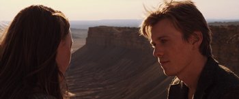 Movie still from “The Host” (2013), directed by Andrew Niccol – Two people standing in front of a mountain side; Close Up shot, Over the shoulder angle