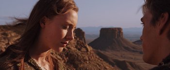 Movie still from “The Host” (2013), directed by Andrew Niccol – A woman standing on top of a mountain looking at the sky; Close Up shot, Low angle