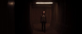 Movie still from “The Host” (2013), directed by Andrew Niccol – A woman standing in a dark tunnel looking at the camera; Wide shot, Low angle