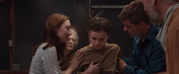 Movie still from “The Host” (2013), directed by Andrew Niccol – A group of people standing next to each other in a room; Medium shot, Over the shoulder angle