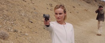 Movie still from “The Host” (2013), directed by Andrew Niccol – A woman holding a gun in her right hand; Close Up shot, Over the shoulder angle